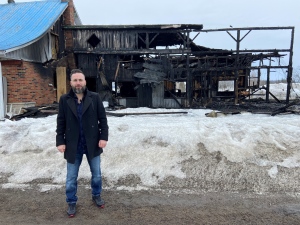 CTV's Cosmo Santamaria stands outside a burned out home following a fire on March 10, 2023. (Christine Long/CTV News)