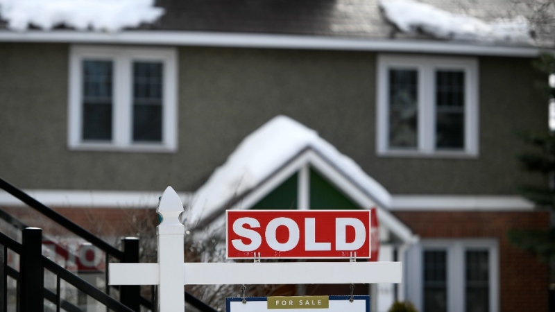 A for sale sign outside a home indicates that it has been sold, in Ottawa, March 1, 2021. THE CANADIAN PRESS/Justin Tang