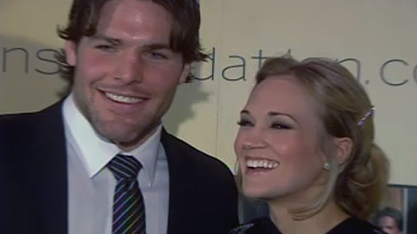 Ottawa Senators forward Mike Fisher and country singer Carrie Underwood take a moment to laugh at the annual Sens Soiree in Gatineau, Monday, Jan. 25, 2010.