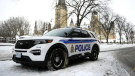 An Ottawa Police officer sits in their cruiser on Wellington Street below Parliament Hill in Ottawa, on Friday, Jan. 27, 2023. THE CANADIAN PRESS/Justin Tang