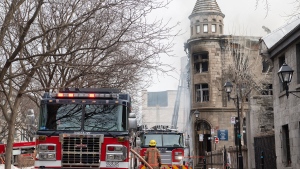 Firefighters are shown at the scene of a fire in Old Montreal, Thursday, March 16, 2023. Residents have been evacuated and multiple people have been treated for injuries. THE CANADIAN PRESS/Graham Hughes