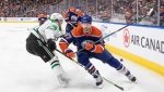 Dallas Stars' Roope Hintz (24) and Edmonton Oilers' Warren Foegele (37) battle for the puck during first period NHL action in Edmonton on Thursday March 16, 2023. (Jason Franson)