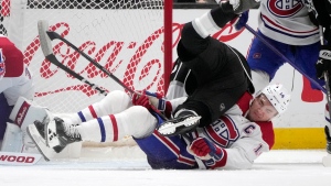 Montreal Canadiens center Nick Suzuki, bottom, collides with Los Angeles Kings center Blake Lizotte during the third period of an NHL hockey game Thursday, March 2, 2023, in Los Angeles. (AP Photo/Marcio Jose Sanchez)
