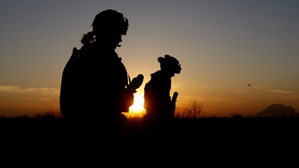 Canadian soldiers from Task Force 3-09 Battle Group are seen in silhouette as they patrol at the start of operation Tazi, a village search and securing operation in the Dand area of Kandahar Province, southern Afghanistan Monday, Jan. 25, 2010. (AP / Kirsty Wigglesworth)