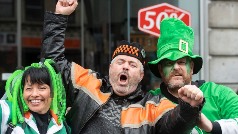 Members of the crowd cheer as the watch the St. Patrick’s Day parade in Montreal, Sunday, March 20, 2022. THE CANADIAN PRESS/Graham Hughes