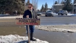 Jamie Ruff puts a sign up at 'Marda Lake' in southwest Calgary (CTV News Calgary).