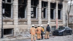 Investigators and firefighters are shown at the scene following a fire in Old Montreal, Saturday, March 18, 2023, that gutted the heritage building. THE CANADIAN PRESS/Graham Hughes