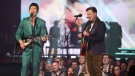 Simu Liu, left, and Ryan Peake of Nickelback perform during the Juno Awards in Edmonton on March 13, 2023. (THE CANADIAN PRESS/Timothy Matwey)