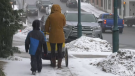 A photo of a mother and her child walking in downtown Bracebridge, taken on Sat., March 18 (Molly Frommer/CTV News). 