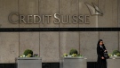 A woman walks past the Credit Suisse bank headquarters in London, Thursday, March 16, 2023. (AP Photo/Frank Augstein)