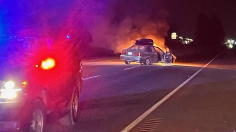 A photo provided by the Abbotsford Police Department shows a car on fire after it was stopped using a spike belt on Sunday, March 19 