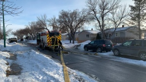 Regina fire personnel at the scene of a house fire on the 100 block of Quebec Street. (Source: Regina fire Twitter)