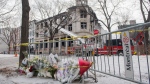A makeshift memorial is shown at the scene following a fire in Old Montreal, Sunday, March 19, 2023, that gutted a heritage building. Several people are still unaccounted for. THE CANADIAN PRESS/Graham Hughes