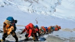In this May 22, 2019, file photo, a long queue of mountain climbers line a path on Mount Everest just below camp four, in Nepal. (AP Photo/Rizza Alee, File)