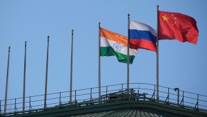 The flags of India, Russia and China flutter on the roof of a hotel with the flags of other countries removed, in central St. Petersburg, Russia, Friday, March 17, 2023. Chinese President Xi Jinping plans to visit Moscow next week, a major boost for Russian President Vladimir Putin amid sharpening East-West tensions over the war in Ukraine and the latest sign of Beijing’s emboldened diplomatic ambitions. (AP Photo/Dmitri Lovetsky)