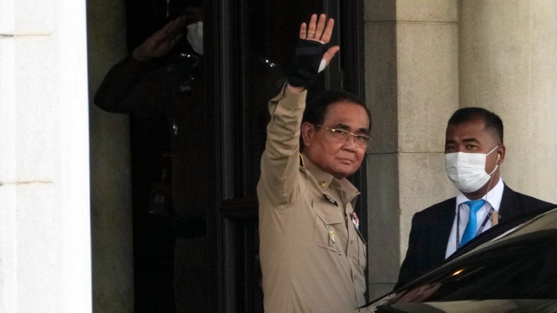 Thailand's Prime Minister Prayuth Chan-ocha waves to reporters as he leaves the Government house in Bangkok, Thailand, Monday, March 20, 2023. Thailand's Parliament was dissolved Monday by a government decree, setting the stage for a May general election, which has the potential to lessen the military's influence in politics. (AP Photo/Sakchai Lalit)