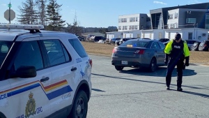 A police officer is pictured outside Charles P. Allen High School in Bedford, N.S., following a weapons complaint on Monday, March 20, 2023. (Bruce Frisko/CTV Atlantic)