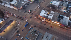 Pylons are set up at 82 Avenue and 99 Street, as well as around a parked van with its hazards on, on March 20, 2023, after a pedestrian was struck in a crosswalk.
