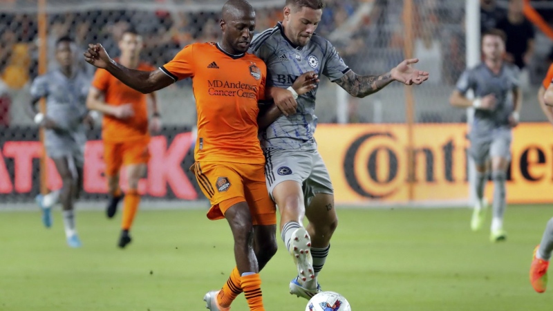 Houston Dynamo midfielder Fafa Picault, left, and CF Montreal defender Gabriele Corbo try to get control of the ball during the second half of an MLS soccer match Saturday, Aug. 13, 2022, in Houston. Corbo is back with CF Montreal following a transfer from Italian club Bologna FC. THE CANADIAN PRESS/AP-Michael Wyke