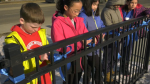 A Grade 4 class at Constable Daniel Woodall School in Edmonton hung blue ribbons on March 20, 2023, in tribute to the EPS officers killed on the job one week earlier. 