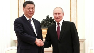 In this handout photo released by Russian Presidential Press Office, Russian President Vladimir Putin, right, and Chinese President Xi Jinping shake hands prior to their talks at the Kremlin in Moscow, Russia, Monday, March 20, 2023. (Russian Presidential Press Office via AP)