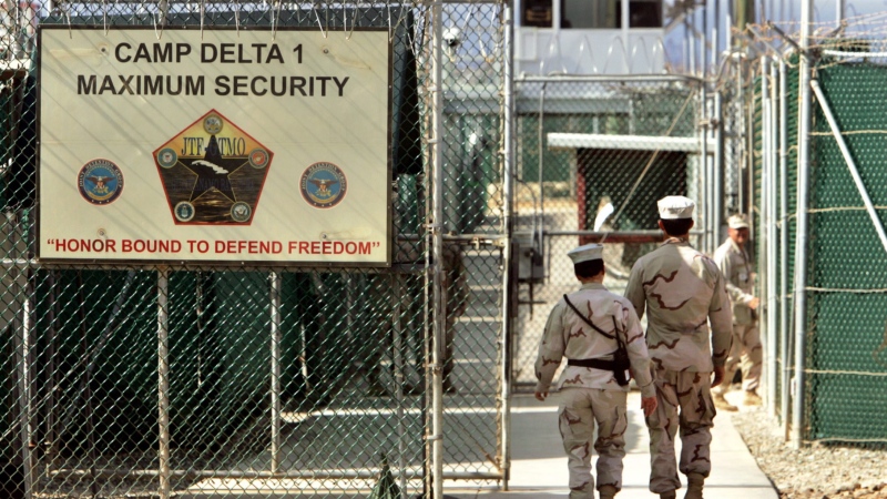 In this file photo made June 27, 2006, reviewed by a U.S. Department of Defense official, U.S. military guards walk within the Camp Delta military-run prison, at the Guantanamo Bay U.S. Naval Base, Cuba. (AP Photo/Brennan Linsley, File)