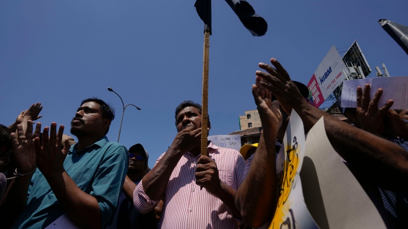 Sri Lankans shout slogans during a protest against the government increasing income tax to manage day to day expenses amid an unprecedented economic crisis in Colombo, Sri Lanka, Wednesday, Feb. 22, 2023. The government says it has been forced to increase taxes because of a severe cash crunch and the success of its talks with the International Monetary Fund depends on a strong public revenue structure. (AP Photo/Eranga Jayawardena)