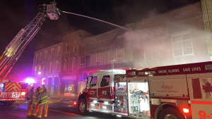 Fire crews tackle a massive blaze on Talbot Street in Aylmer on the evening of March 20, 2023. (Source: Aylmer Police Service/Facebook) 