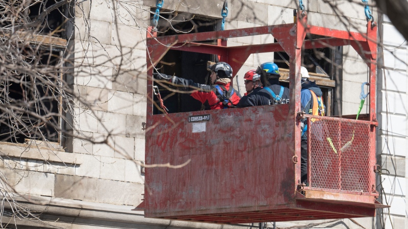 Firefighters continue the search for victims Monday, March 20, 2023 at the scene of last week’s fire that left one person dead and six people missing in Montreal.THE CANADIAN PRESS/Ryan Remiorz