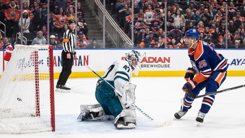 San Jose Sharks goalie James Reimer (47) is scored on by Edmonton Oilers' Darnell Nurse (25) during overtime NHL action in Edmonton on Monday March 20, 2023.THE CANADIAN PRESS/Jason Franson