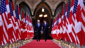 Prime Minister Justin Trudeau and then-U.S. Vice-President Joe Biden walk down the Hall of Honour on Parliament Hill in Ottawa on Dec. 9, 2016. (THE CANADIAN PRESS/Patrick Doyle)