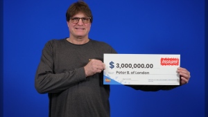 Peter Baxted of London, Ont. picking up hias $3-million prize at the OLG Centre in Toronto. (Source: OLG)