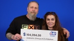 Robert Pasquini and Anabell Alonso of Beeton, Ont., hold their big cheque after winning Lotto 6/49. (OLG)