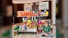 Ethan Millman poses with the food he raised, and the amount of money he raised for the Guelph Food Bank. (Bobbi Millman/Submitted)