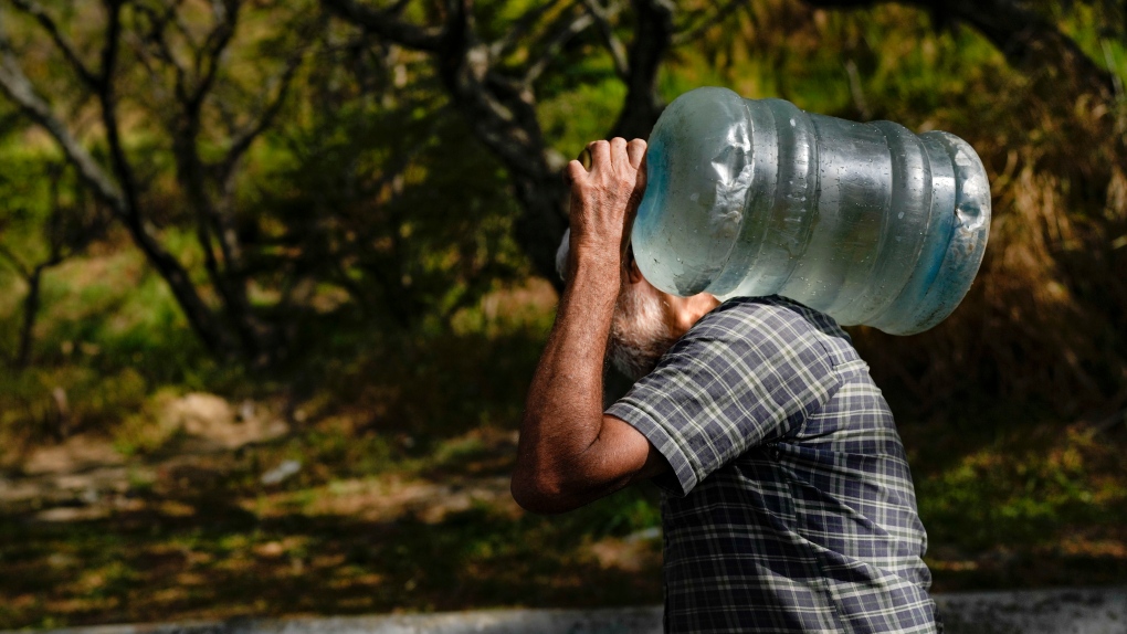 Man carries water in Venezuela