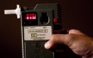 An RCMP constable holds a breathalyzer device in Surrey, B.C., in this file photo. (The Canadian Press/Darryl Dyck)