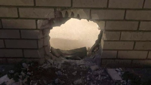 This photo provided by Newport News Sheriff's Office shows a hole in the wall of a prison cell in Newport News, Va., on March 20, 2023.  (Newport News Sheriff's Office via AP)