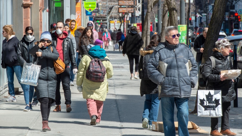 Pedestrians walk down St. Catherine Street, Monday, April 6, 2020 in Montreal. (THE CANADIAN PRESS/Ryan Remiorz)