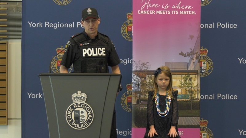 Charlotte Wilson, 5, (R), is this year's child ambassador, with her father, York Regional Police Const. Joe Wilson (L) on March 22, 2023. (CTV News/Molly Frommer)