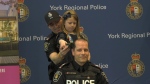 Charlotte Wilson, 5, helps shave the head of an officer with help from her father, York Regional Police Const. Joe Wilson on March 22, 2023. (CTV News/Molly Frommer)