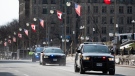 Ontario Provincial Police (OPP) vehicles speed along Wellington Street in preparation of U.S. President Joe Biden's visit in Ottawa on Wednesday, March 22, 2023. (Spencer Colby/THE CANADIAN PRESS)