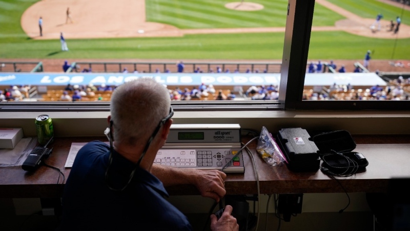 The pitch clock is operated in the press box during the sixth inning of a spring training baseball game between the San Diego Padres and the Los Angeles Dodgers in Glendale, Calif., Monday, March 6, 2023. (AP Photo/Ashley Landis)