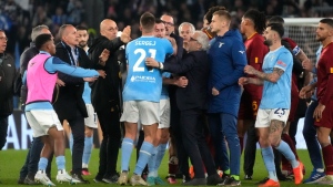 Players scuffle after the Italian Serie A soccer match between Lazio and Roma at Rome's Olympic stadium, Sunday, March 19, 2023. (AP Photo/Gregorio Borgia)