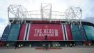 Security and stewards stand outside the Old Trafford stadium in Manchester, England, Tuesday, May 11, 2021 ahead of the English Premier League soccer match between Manchester United and Leicester City. (AP Photo/Jon Super, FIle)