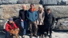 Concerned citizens Jill Blakeney, Peter Barss, Paul Newton and Karen Reinhardt stand in front of a large rock wall at Little Crescent Beach in Nova Scotia's Lunenburg County. (Heidi Petracek/CTV Atlantic)