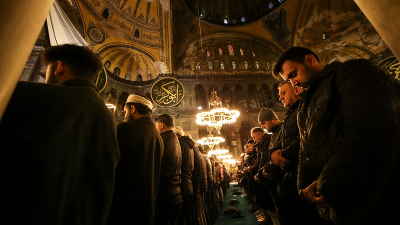 Muslim worshippers perform a night prayer called 'tarawih' during the eve of the first day of the Muslim holy fasting month of Ramadan in Turkey at Hagia Sophia mosque in Istanbul, Turkey, Wednesday, March 22, 2023. (AP Photo/Emrah Gurel)