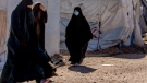 Women walk in Roj detention camp in northeast Syria, on Feb. 9, 2022. (Baderkhan Ahmad / AP) 