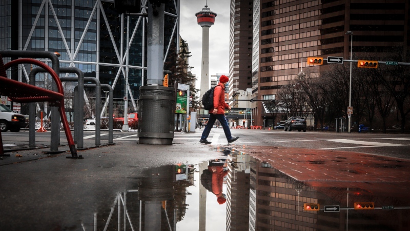 A pedestrian walks through downtown Calgary on Dec. 9, 2020. Statistics Canada data suggests more people are moving to Alberta from other Canadian provinces than ever before, leading the UCP government to say their 'Alberta is Calling' campaign is working out. THE CANADIAN PRESS/Jeff McIntosh