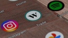 A Wealthsimple Trade app icon is shown on a smartphone on Tuesday, Dec. 15, 2020. THE CANADIAN PRESS/Jesse Johnston