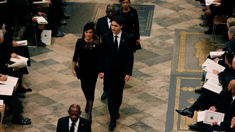 Prime Minister Justin Trudeau and his wife Sophie Gregoire Trudeau arrive at Westminster Abbey ahead of the State Funeral of Britain's Queen Elizabeth II, in London, Monday Sept. 19, 2022. (Jack Hill/Pool Photo via AP)